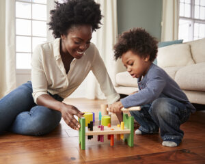 image of a mother and son playing on the floor together. Showing the outcome you could get from parent coaching and educational consulting in Washington DC, Baltimore, and Columbia, MD.