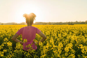 Image of a woman in a pink shirt standing in a field of yellow flowers. Are you interested in how EMDR therapy in Baltimore, MD can help you? We can help you decide if EMDR is right for you. Reach out to speak with an EMDR therapist in Columbia, MD 21737. Contact us today!