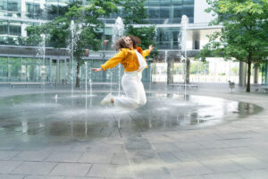 Image of a young adult jumping in the air near fountains. Are you searching for depression help in Blatimore, MD? we offer depression treatment in Baltimore, MD. Our depression therapist in Columbia, MD can help you. Call today to get rid of your depression symptoms in the Washington D.C. area.