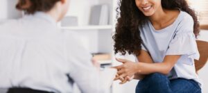 Image of a woman meeting with a therapist for women in the Washington DC area. Showing what you can expect from counseling for women in Baltimore. Which is a place where women mental health is prioritized.